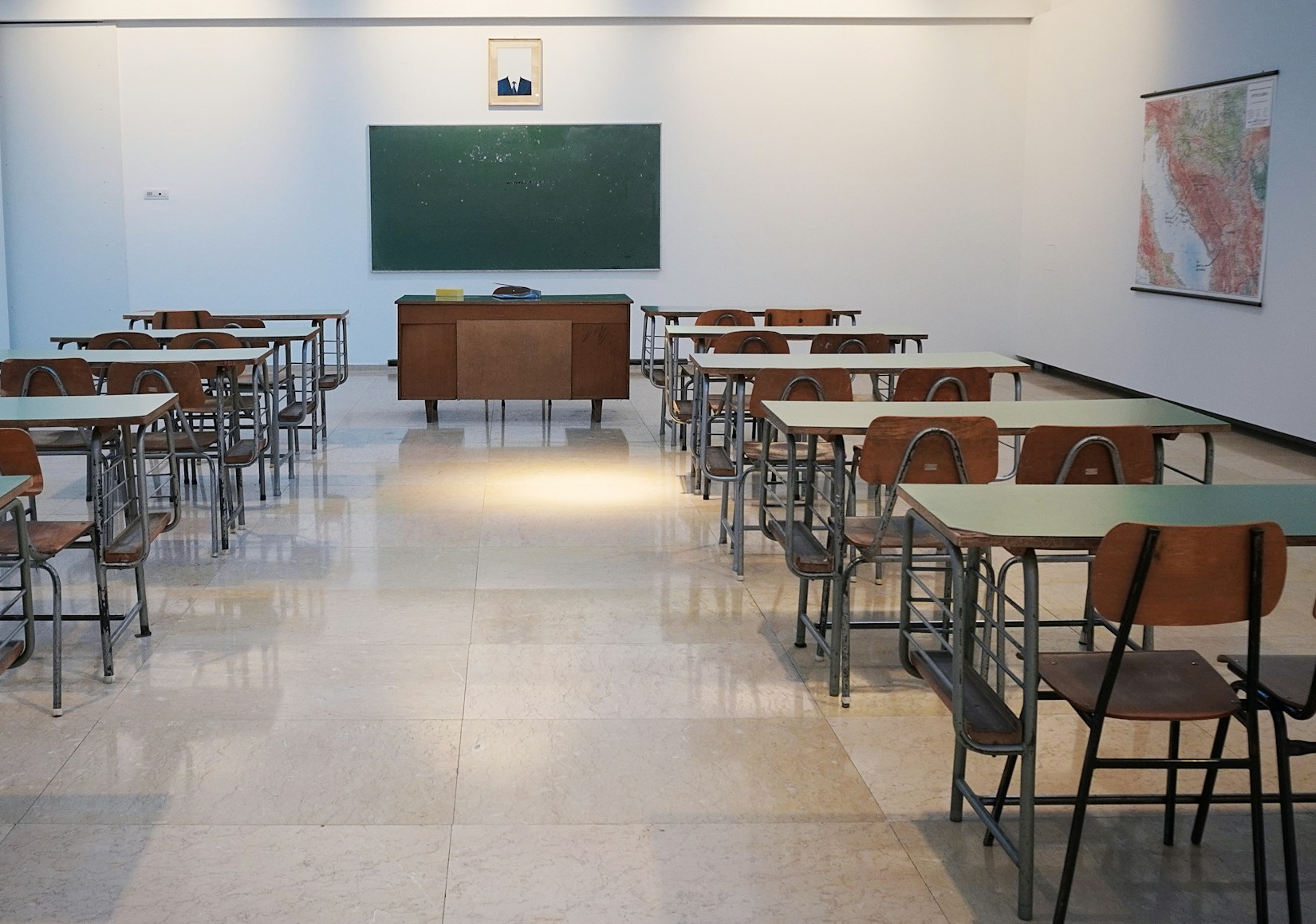 Empty classroom with desks and chalkboard Empty classroom with desks and chalkboard
