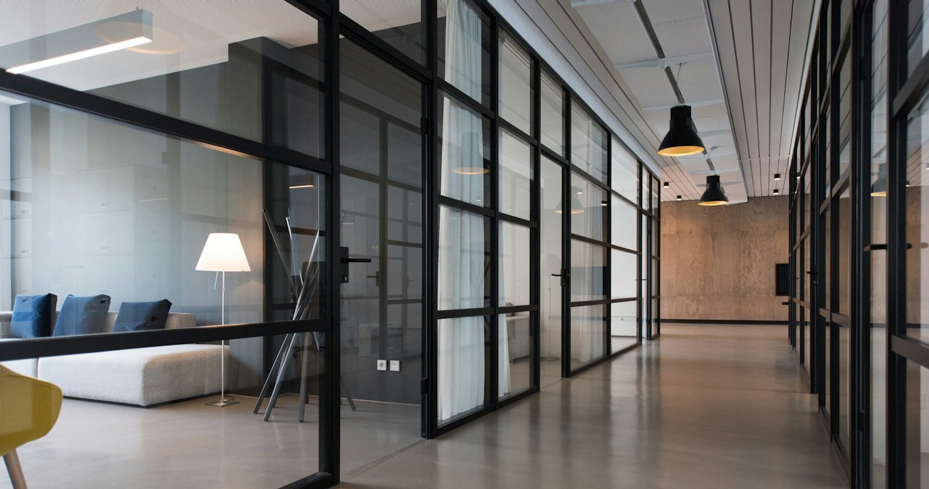 Office corridor between glass-panel partitions Office corridor between glass-panel partitions