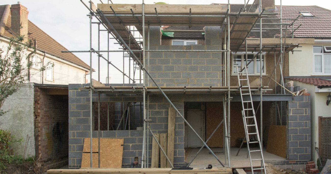 House extension under construction with scaffolding House extension under construction with scaffolding