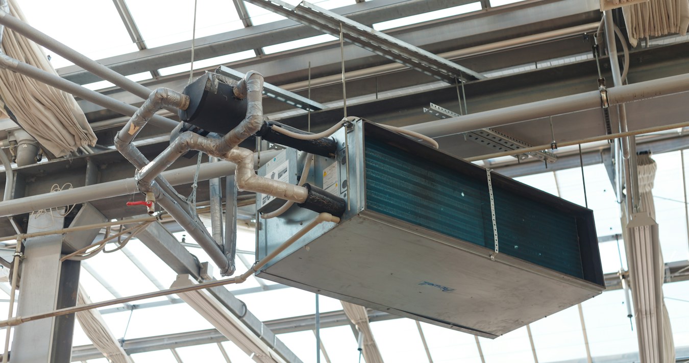 HVAC unit suspended from a roof structure HVAC unit suspended from a roof structure